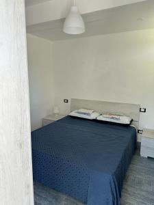 - une chambre avec un lit bleu dans l'établissement Riva del Golfo Casa Vacanze, à Campora San Giovanni
