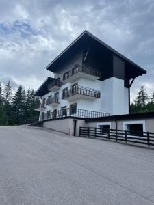 a large white building with a black roof at San Antonio Chalet in Padola