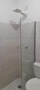 a bathroom with a glass shower with a toilet at Central Palace Hotel in Fortaleza