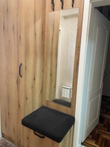 bagno con specchio e panca nera di Stan u centru, Loznica a Loznica