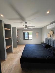 een slaapkamer met een bed en een plafondventilator bij Villa Gobernador Bonaire in Kralendijk