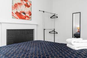 a bedroom with a bed and a fireplace at London Downtown Home in London