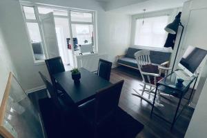 a living room with a table and chairs and a couch at City Loft - O2 & Excel Center in London