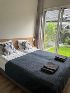 a bedroom with a bed with two towels on it at Apartamenty A1 in Gdynia