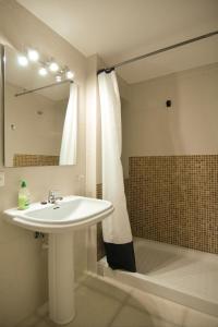 a bathroom with a sink and a shower with a mirror at Brisas Vista Mar in Sa Ràpita