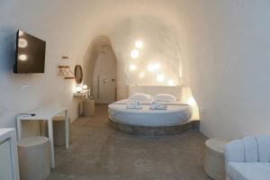 a bedroom with a large bed with lights on the wall at Naos Suites in Vóthon
