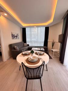 a living room with a table and a couch at HADRİANS TOWER in Antalya