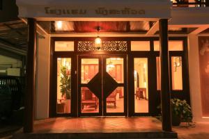 a front door of a building with a sign on it at Phongsavath Boutique Hotel in Vientiane