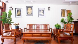 a dining room with a wooden table and two chairs at Phongsavath Boutique Hotel in Vientiane +37 photos