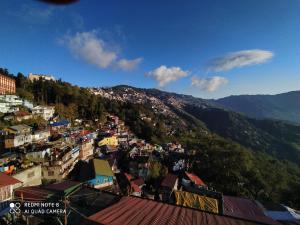 a view of a city with a mountain at Sparrow Nest Homestay in Darjeeling