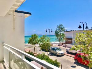 a view of the beach from a balcony of a building at La Cala Beach Home - beachfront few steps away from sandy beach in La Cala de Mijas