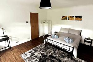 a bedroom with a bed and a rug at Luxury, Spacious 1 Bedroom Flat in South Norwood