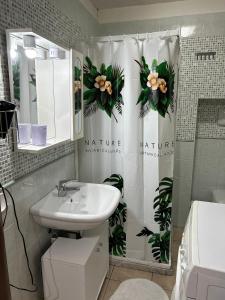 a bathroom with a sink and a shower curtain at Sweet home in Noto +15 photos
