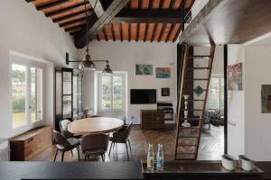 a living room with a wooden table and chairs at The River View in Florence "Costante Art & Design" in Florence