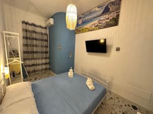 a bedroom with a bed with two bags on it at Ca Sà Bellò San Vito Lo Capo in San Vito lo Capo