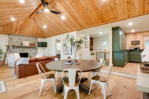 a dining room and living room with a table and chairs at Spacious Home on Beaver Lake with Deck and Fire Pit! in Rogers