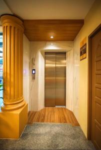a hallway with a large yellow column in a building at Leda Seaview Room in Ban Saiyuan (1)