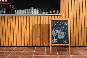 a chalkboard sign sitting in front of a bar at Real Bellavista Hotel & Spa in Albufeira