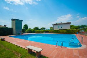 una gran piscina con un banco al lado en Italianflat - Villetta Bellavista, en Bardolino