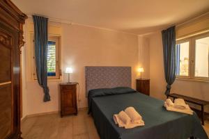 Letto o letti in una camera di Borgo Marino Plemmirio