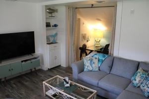 a living room with a couch and a flat screen tv at Mermaid Manor in Homosassa