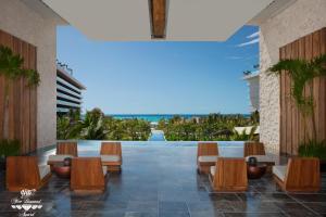 a lobby with chairs and a view of the ocean at Secrets Moxché Playa del Carmen - Adults Only - All Inclusive in Playa del Carmen