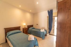 Letto o letti in una camera di Borgo Marino Plemmirio