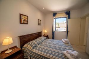 Letto o letti in una camera di Borgo Marino Plemmirio