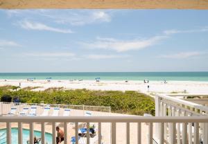 a view of the beach from the balcony of a beach house at Emerald at Belleair Beach Club in Clearwater Beach +275 photos
