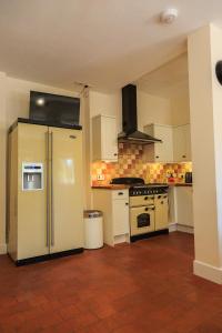 a kitchen with a refrigerator and a stove at The Old Chemist in Burley