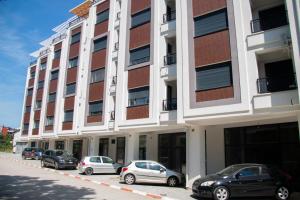 a row of cars parked in front of a building at Vasilije in Vrnjačka Banja
