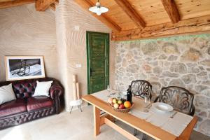 a living room with a table and a couch at Villa Teza Hvar in Hvar