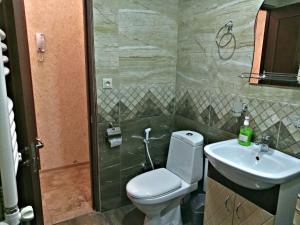 a bathroom with a toilet and a sink at Luxury Apartment Nearby Northern Avenue , Middle of Center ( Самый Центр, 3х Комнатная Современная Квартира ) in Yerevan +12 photos
