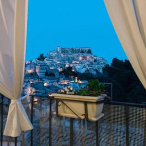 a balcony with a view of a city at night at La Casa di Matilde in Ragusa
