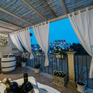 a room with a balcony with a view of a city at La Casa di Matilde in Ragusa