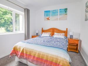 a bedroom with a bed and a window at Dolphin Villa in Newquay
