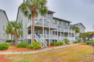 a large apartment building with white balconies and palm trees at Luxe Island Condo with Deck Play, Swim and Relax! in Oceanmarsh Subdivision