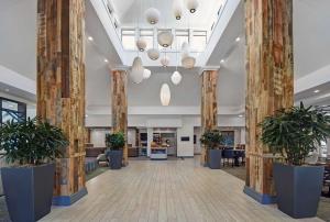 a lobby with columns and potted plants at Hilton Garden Inn Houston/Galleria Area in Houston