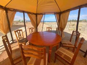 a wooden table and chairs in a tent at Guest house "U apashki" in Tong