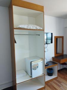 a room with an open closet with a tv in it at Marine Bay Hotel in Sandakan