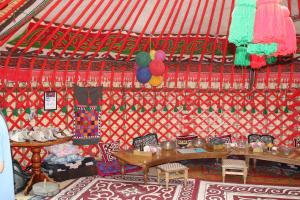 a room with tables and chairs in a yurt at Guest House Emily in Bokonbayevo