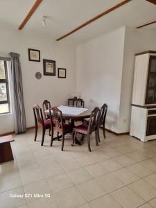 a dining room with a table and chairs at 1 bedroom Morleen Park apartment in Swakopmund