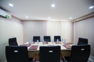 a meeting room with a long table and chairs at Hotel L Odeon Phu My Hung in Ho Chi Minh City