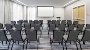 a conference room with chairs and a projection screen at Canopy By Hilton Atlanta Midtown in Atlanta