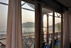 a view of the beach from a window at Sai Valentines in Canacona +41 photos