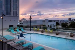 a swimming pool on the roof of a building at Hilton Garden Inn Orlando Downtown in Orlando