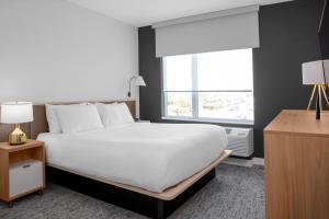 a bedroom with a large white bed and a window at TownePlace Suites by Marriott Tampa Clearwater in Clearwater