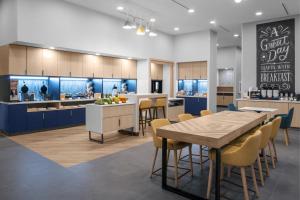 a kitchen with a table and chairs and a counter at TownePlace Suites by Marriott Tampa Clearwater in Clearwater