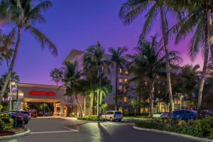 a parking lot with palm trees in front of a hotel at Hampton Inn Fort Lauderdale Plantation in Plantation