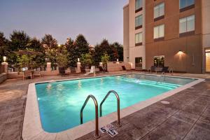a large swimming pool in front of a building at Hilton Garden Inn Jackson in Jackson